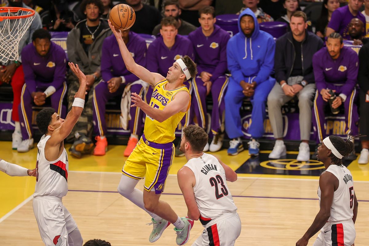 #15 G Austin Reaves of the Los Angeles Lakers drives the lane for a layup during an NBA game against the Sacramento Kings on October 17, 2025 in Los Angeles, CA.