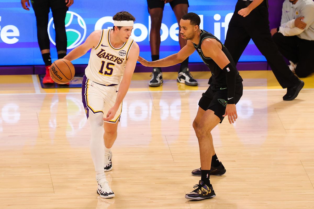 #15 G Austin Reaves of the Los Angeles Lakers dribbles the basketball during an NBA game against the New Orleans Pelicans on November 30, 2025 in Los Angeles, CA.