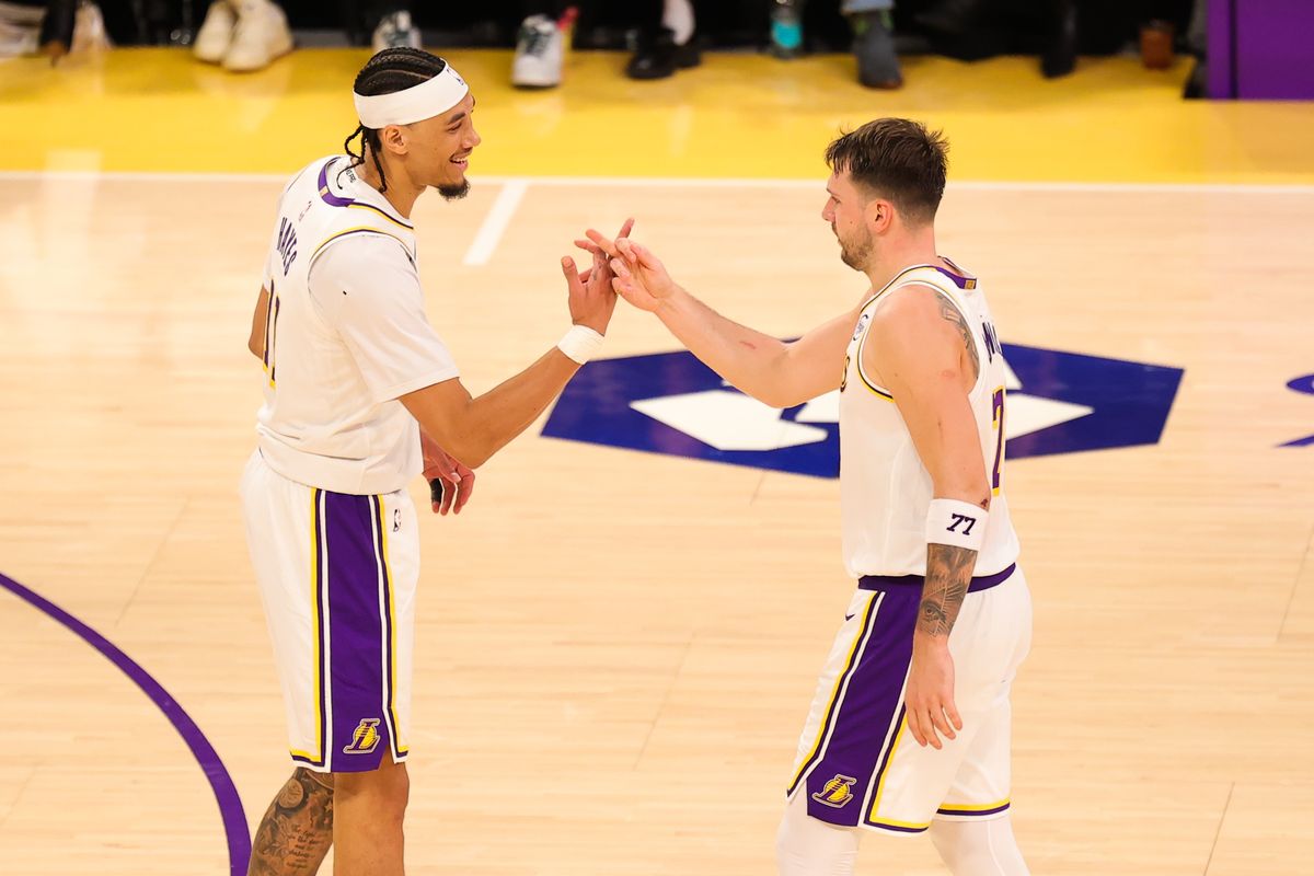 #77 PG Luka Doncic and #11 C Jaxson Hayes of the Los Angeles Lakers celebrate a made basket during an NBA game against the New Orlean Pelicans on November 30, 2025 in Los Angeles, CA.