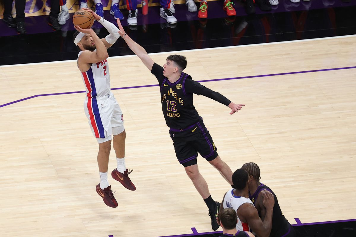 #12 F Jake LaRavia of the Los Angeles Lakers closes out on #2 PG Cade Cunningham of the Detroit Pistons during an NBA game on December 30, 2025 in Los Angeles, CA.