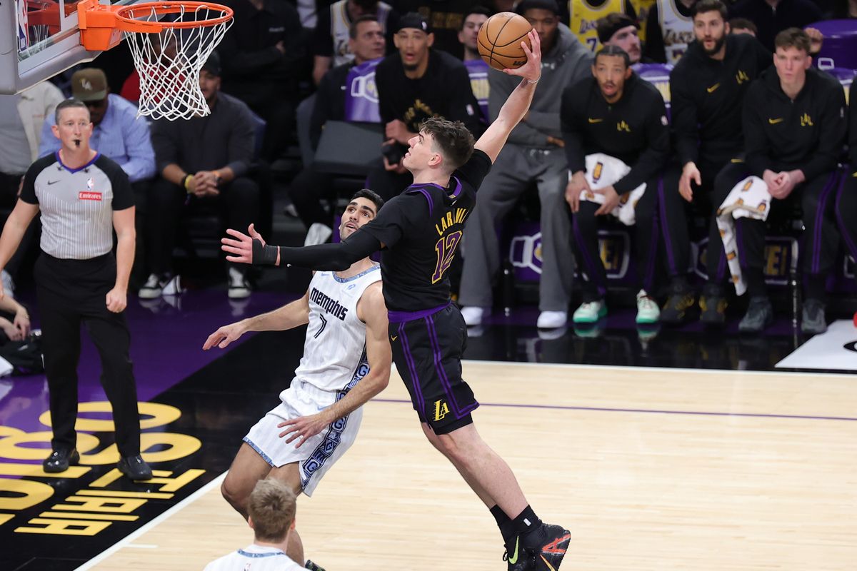 #12 F Jake LaRavia of the Los Angeles Lakers drives in for a slam dunk during an NBA game against the Memphis Grizzlies on January 2, 2026 in Los Angeles, CA.