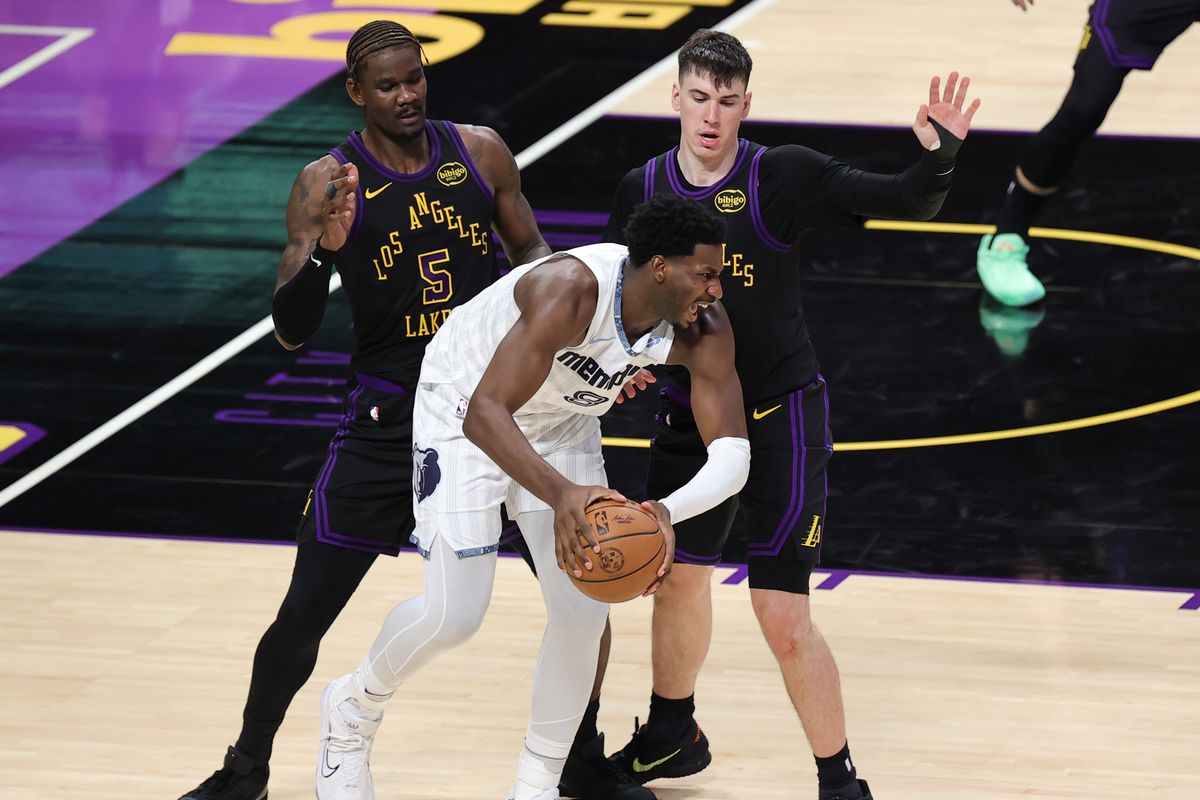 #5 C Deandre Ayton and #12 F Jake LaRavia of the Los Angeles Lakers defend against #8 F/C Jaren Jackson Jr. of the Memphis Grizzlies during an NBA game on January 2, 2026 in Los Angeles, CA.