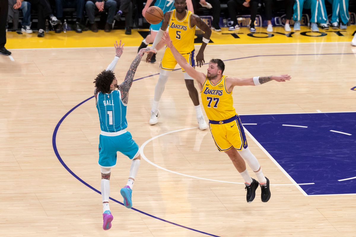 LaMelo Ball #1 of the Charlotte Hornets shoots a three point shot over Luka Doncic #77 of the Los Angeles Lakers during an NBA basketball game against the Charlotte Hornets, Thursday January 15, 2026 in Inglewood, Calif.