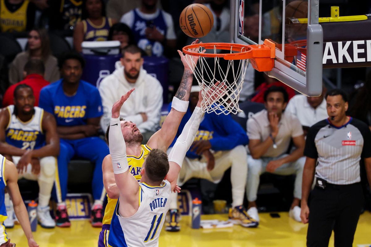 Luka Dončić #77 of the Los Angeles Lakers lays the ball up over Micah Potter #11 of the Indiana Pacers during an NBA basketball game, Friday March 6, 2026 in Los Angeles, Calif.