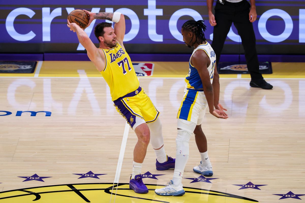 Luka Dončić #77 of the Los Angeles Lakers tries to avoid the backcourt violation as Aaron Nesmith #23 of the Indiana Pacers defends during an NBA basketball game, Friday March 6, 2026 in Los Angeles, Calif.