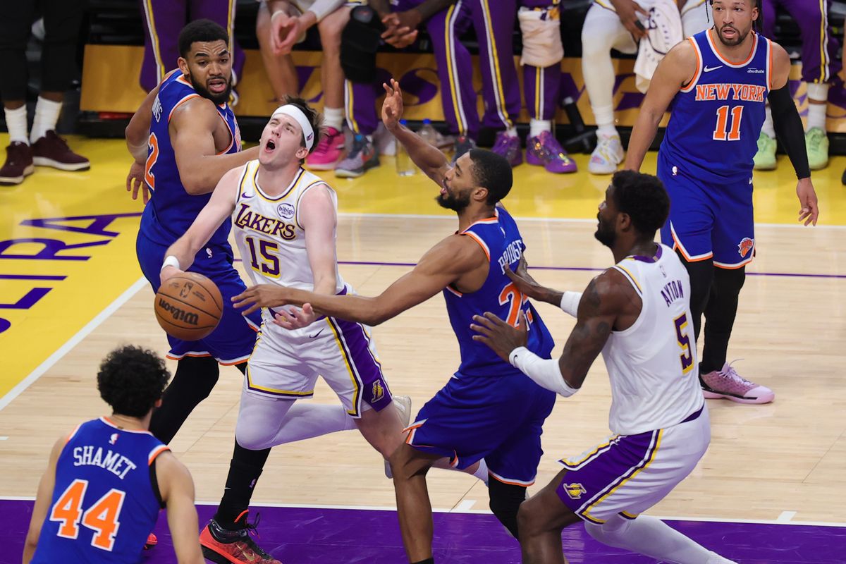 Los Angeles Lakers guard Austin Reaves (15) is fouled driving the lane during an NBA game against the New York Knicks on March 8, 2026 in Los Angeles, CA.