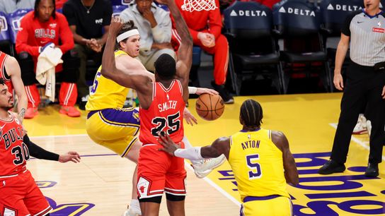 Austin Reaves #15 of the Los Angeles Lakers passes the ball around Jalen Smith #25 of the Chicago Bulls during an NBA basketball game, Thursday March 12, 2026 in Los Angeles, Calif.