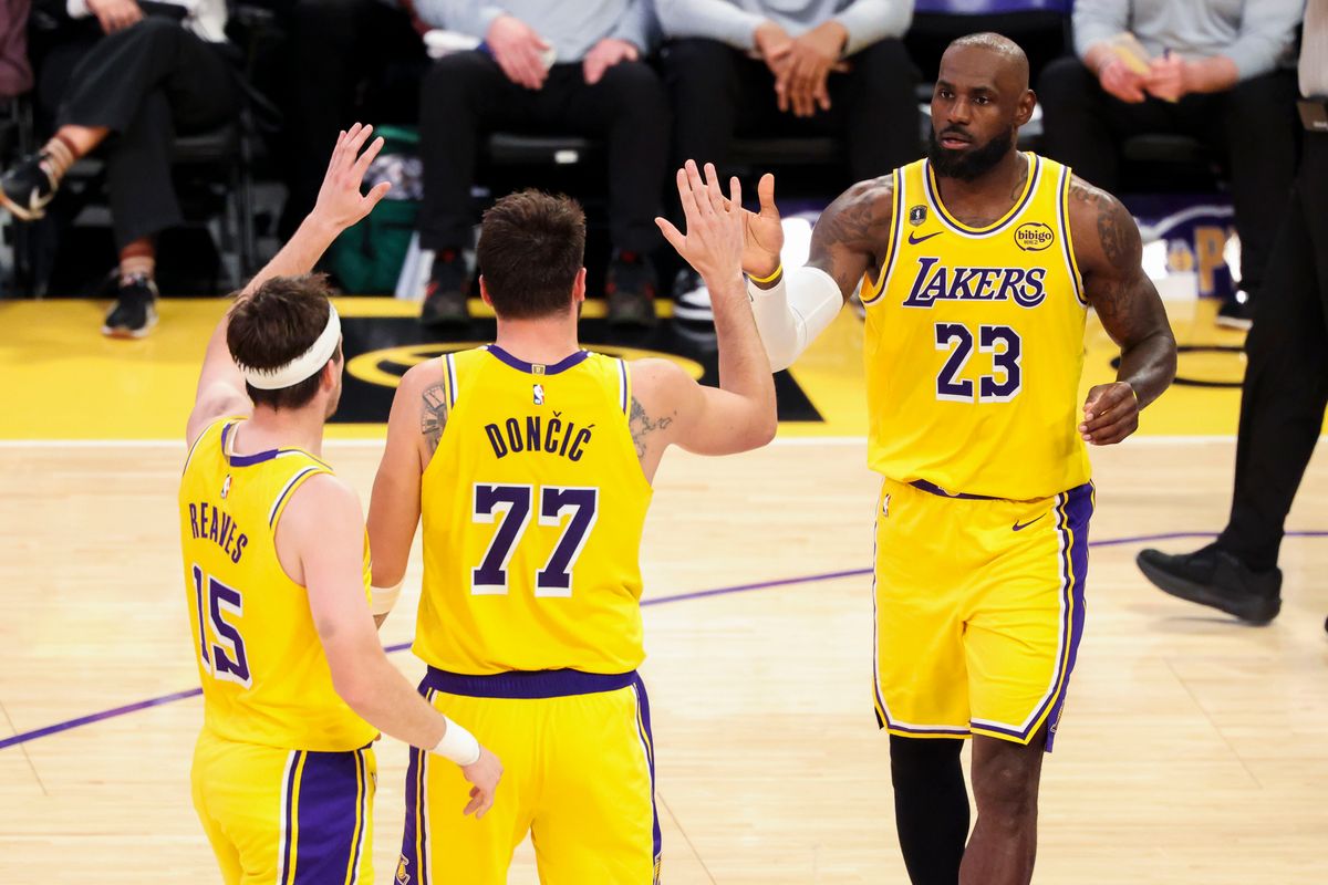 LeBron James #23 high fives Luka Dončić #77 and Austin Reaves #15 of the Los Angeles Lakers during an NBA basketball game against the Chicago Bulls, Thursday March 12, 2026 in Los Angeles, Calif.