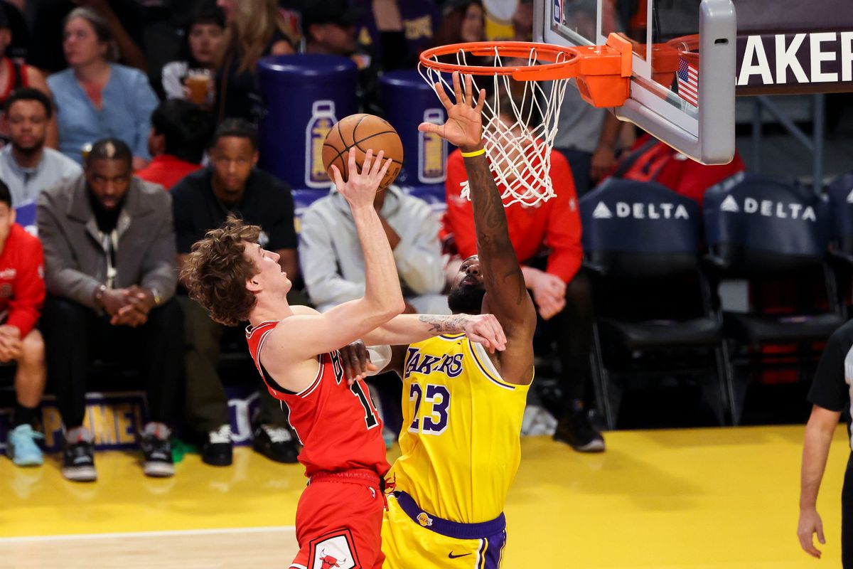 Matas Buzelis #14 of the Chicago Bulls lays the ball up over LeBron James #23 of the Los Angeles Lakers during an NBA basketball game, Thursday March 12, 2026 in Los Angeles, Calif.