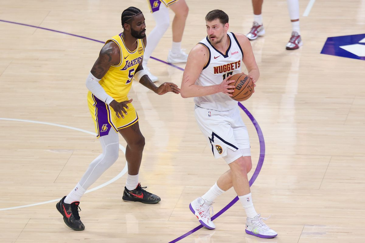Los Angeles Lakers center Deandre Ayton (5) defends against Denver Nuggets center Nikola Jokic (15) during an NBA game on March 14, 2026 in Los Angeles, CA. Los Angeles Lakers center Deandre Ayton (5) defends against Denver Nuggets center Nikola Jokic (15) during an NBA game on March 14, 2026 in Los Angeles, CA.