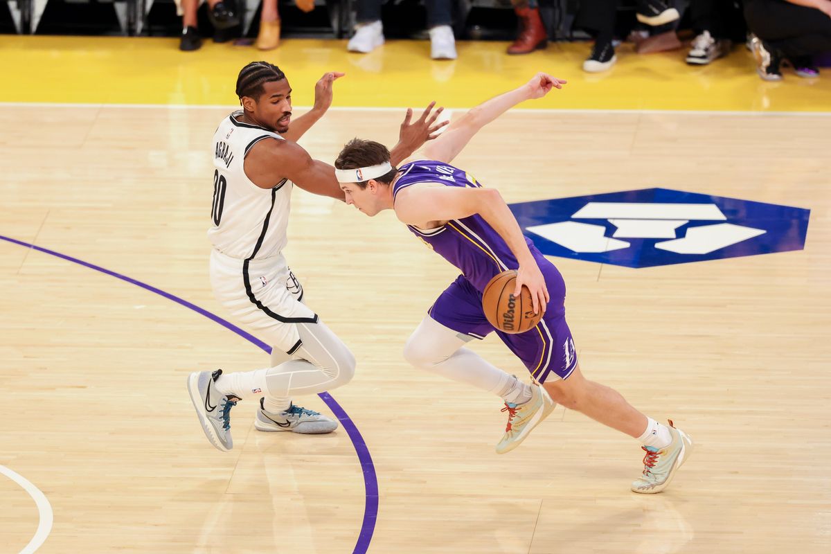 Austin Reaves #15 of the Los Angeles Lakers drives past Ochai Agbaji #30 of the Brooklyn Nets during an NBA basketball game, Friday March 27, 2026 in Los Angeles, Calif.