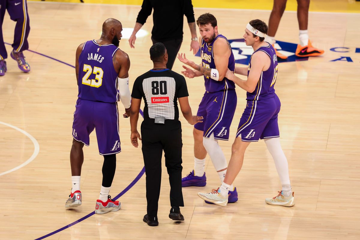 LeBron James #23, Luka Doncic #77, and Austin Reaves #15 of the Los Angeles Lakers plead their case to referee JD Ralls during an NBA basketball game against the Brooklyn Nets, Friday March 27, 2026 in Los Angeles, Calif.
