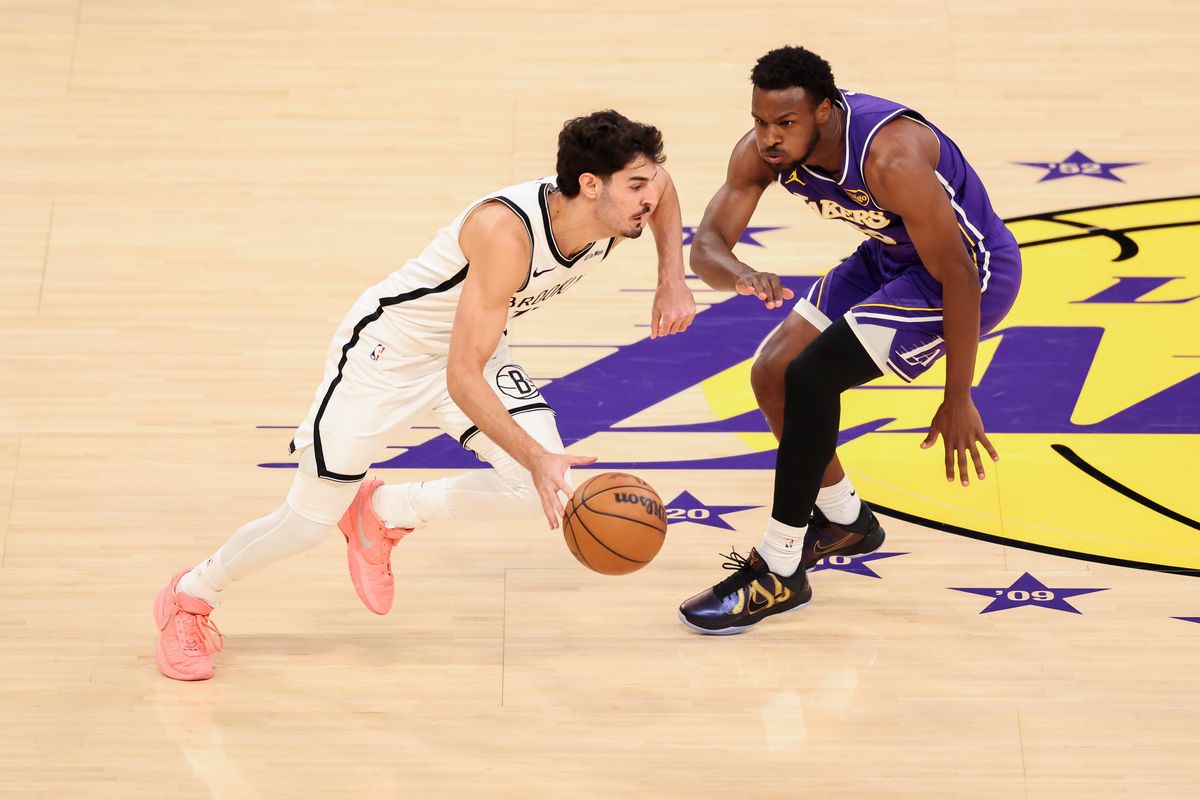 Ben Saraf #77 of the Brooklyn Nets dribbles the ball up the court against Bronny James #9 of the Los Angeles Lakers during an NBA basketball game, Friday March 27, 2026 in Los Angeles, Calif.