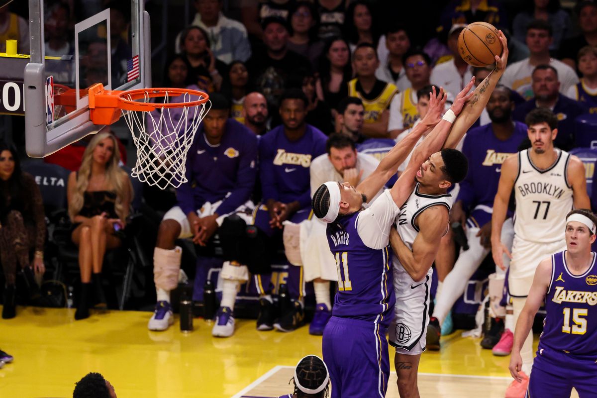 Josh Minott #00 of the Brooklyn Nets reaches way back to attempt a dunk over Jaxson Hayes #11 of the Los Angeles Lakers during an NBA basketball game, Friday March 27, 2026 in Los Angeles, Calif.