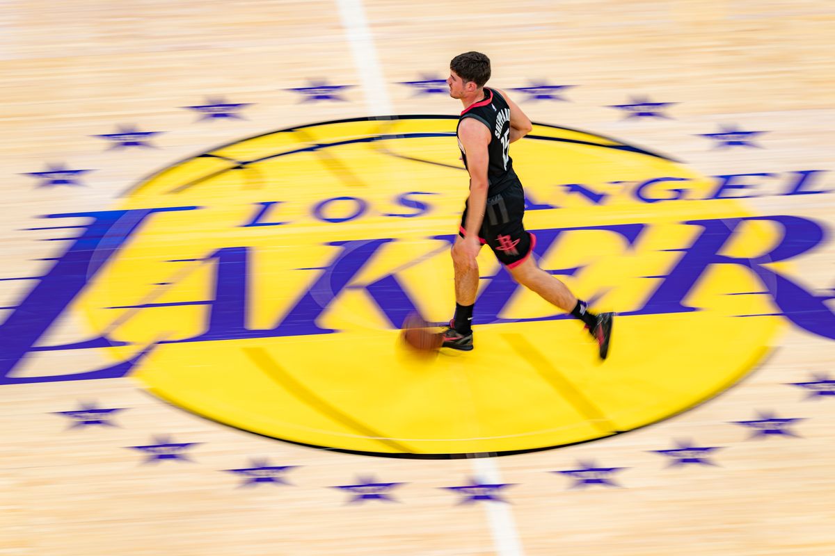Houston Rockets guard Reed Sheppard (15) dribbling over the center court logo during an NBA basketball game against the Los Angeles Lakers on April 18th, 2026 in Los Angeles, CA.
