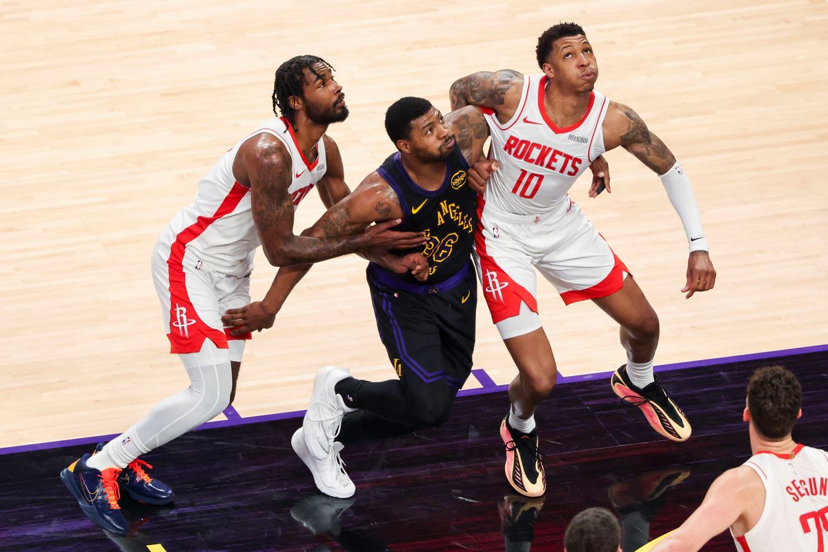 Tari Eason #17 and Jabari Smith Jr. #10 of the Houston Rockets battle Marcus Smart #36 of the Los Angeles Lakers for a rebound during an NBA Playoffs basketball game, Tuesday April 21, 2026 in Los Angeles, Calif.
