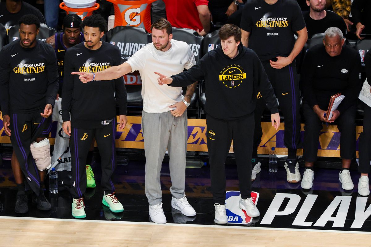 Luka Doncic #77 and Austin Reaves #15 of the Los Angeles Lakers point on the bench during an NBA Playoffs basketball game against the Houston Rockets, Tuesday April 21, 2026 in Los Angeles, Calif.
