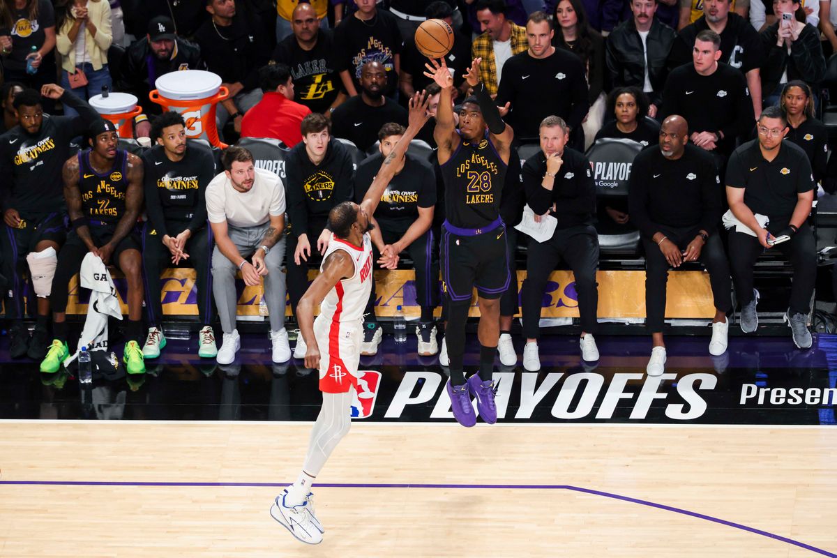 Rui Hachimura #28 of the Los Angeles Lakers shoots a three pointer over Kevin Durant #7 of the Houston Rockets in front of the Lakers bench during an NBA Playoffs basketball game, Tuesday April 21, 2026 in Los Angeles, Calif.