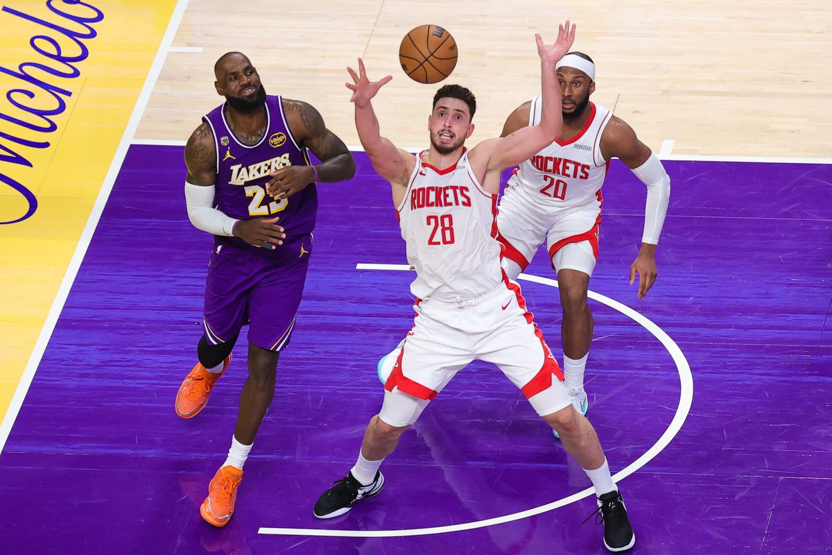 Los Angeles Lakers forward LeBron James (23) and Houston Rockets center Alperen Sengun (28) attempt to secure the loose ball during an NBA playoffs game on April 29, 2026 in Los Angeles, CA.