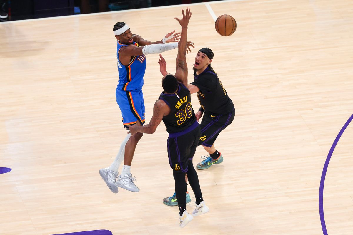 Shai Gilgeous-Alexander #2 of the Oklahoma City Thunder passes the ball through the double team during an NBA Playoffs basketball game against the Los Angeles Lakers, Monday May 11, 2026 in Los Angeles, Calif.