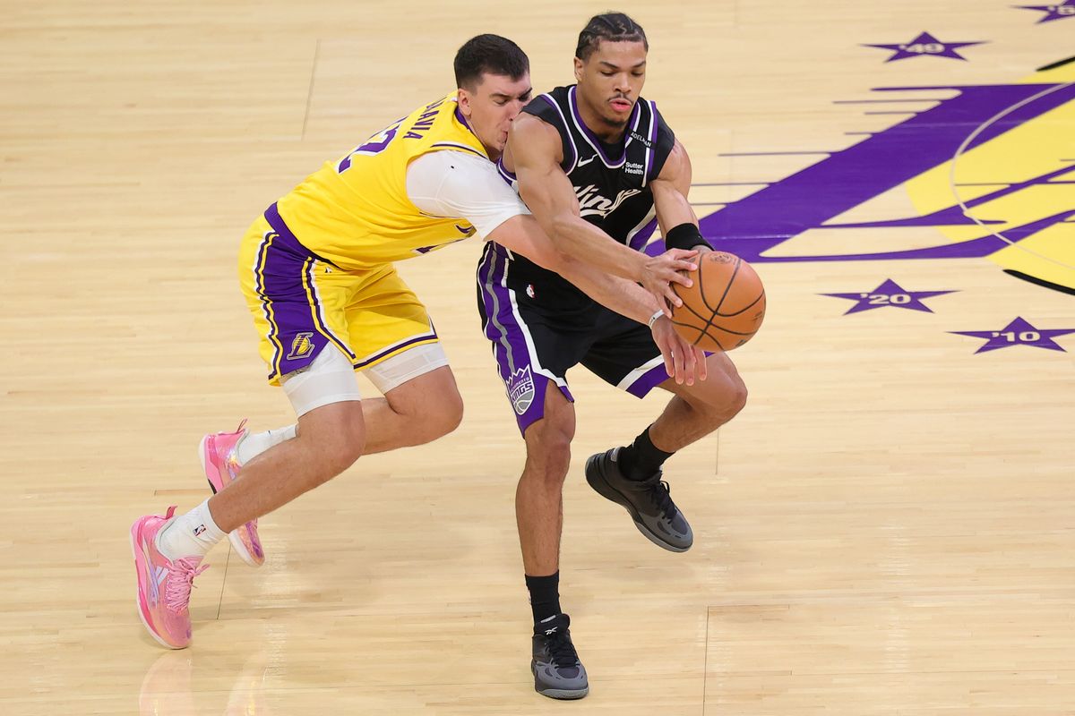Los Angeles Lakers F Jake LaRavia (12) attempts to steal the ball during an NBA basketball game against the Sacramento Kings, Thursday October 8, 2026 in Los Angeles, Calif. Los Angeles Lakers F Jake LaRavia (12) attempts to steal the ball during an NBA basketball game against the Sacramento Kings, Thursday October 8, 2026 in Los Angeles, Calif.