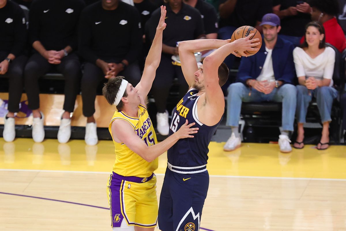 Los Angeles Lakers G Austin Reaves (15) defends against Denver Nuggets C Nikola Jokic (15) during an NBA basketball game, Friday October 16, 2026 in Los Angeles, Calif.