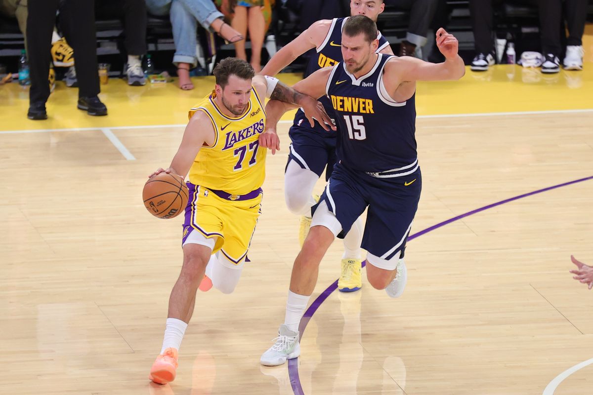 Los Angeles Lakers PG Luka Doncic (77) drives the lane against Denver Nuggets C Nikola Jokic (15) during an NBA basketball game, Friday October 16, 2026 in Los Angeles, Calif.