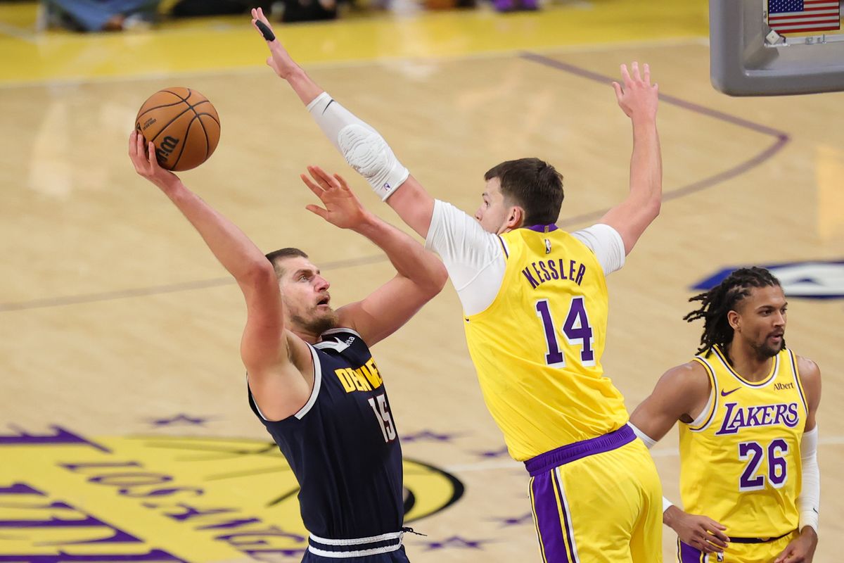 Los Angeles Lakers C Walker Kessler (15) defends against Denver Nuggets C Nikola Jokic (15) during an NBA basketball game, Friday October 16, 2026 in Los Angeles, Calif.