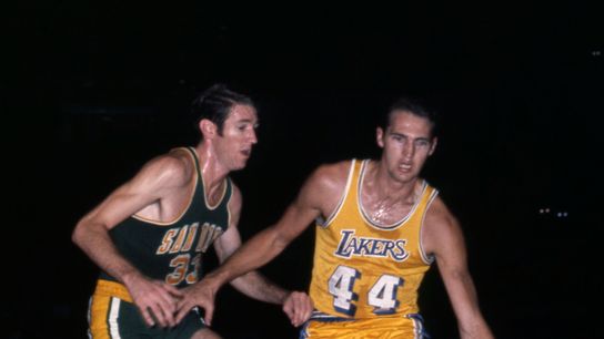 Los Angeles Lakers guard Jerry West (44) is defended by San Diego Rockets forward Jim Barnett (33) at the Forum.