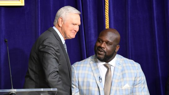 Jerry West (left) shakes hands with Los Angeles Lakers former center Shaquille O'Neal during ceremony to unveil statue of O'Neal at Staples Center.
