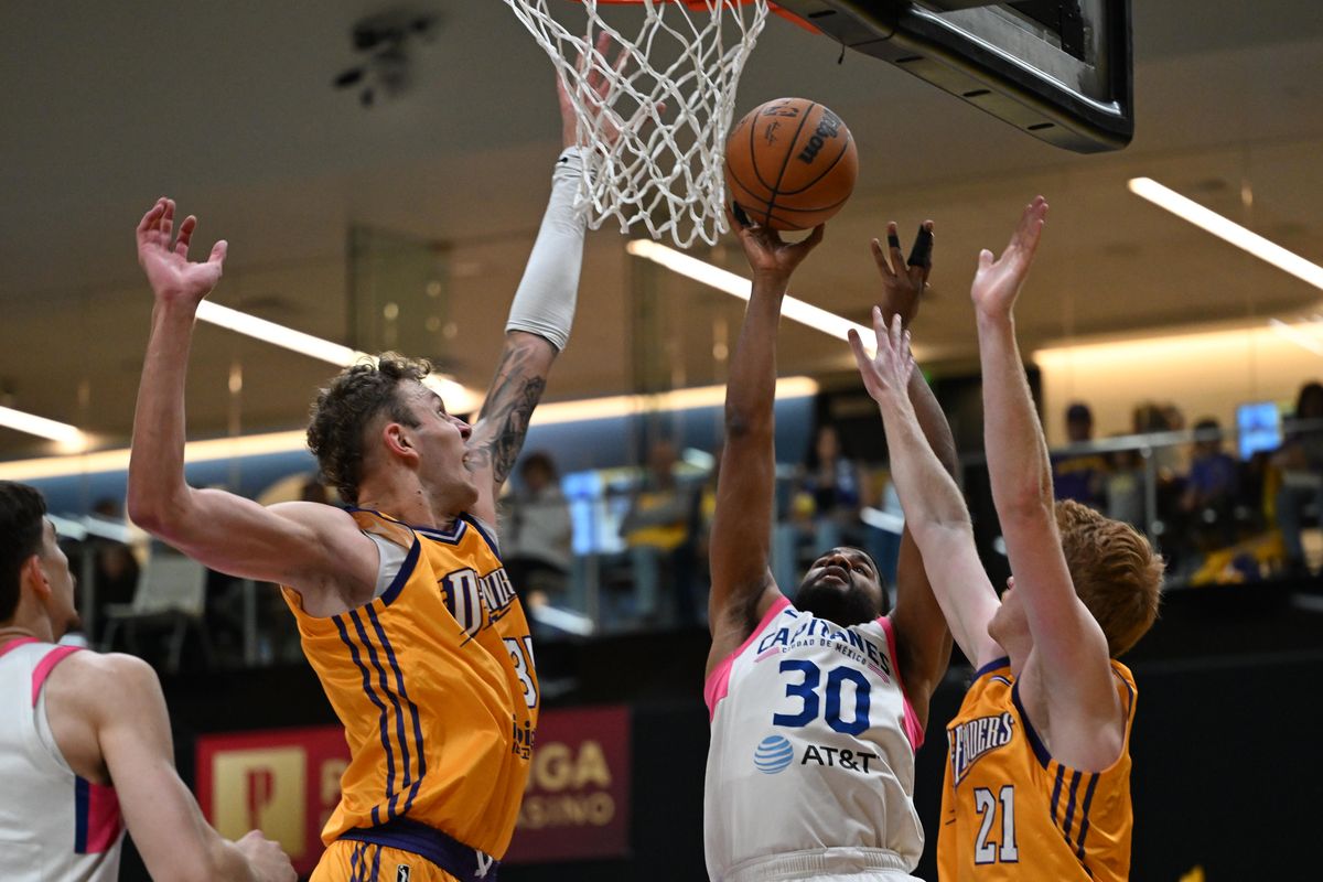 Mexico City Capitanes Small Forward LJ Figueroa (30) scores against two defenders during a G-League basketball game between the South Bay Lakers and  and Mexico City Capitanes Saturday, January 24, 2026 at UCLA Health Training Center in El Segundo, Calif.