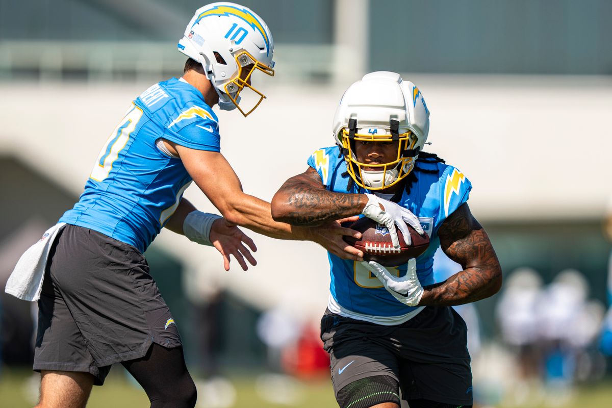 Los Angeles Chargers quarterback Justin Herbert (10) handing the ball off to running back Omarion Hampton (8) during Chargers training camp at The Bolt on Friday, July 31th in El Segundo, CA. Los Angeles Chargers quarterback Justin Herbert (10) handing the ball off to running back Omarion Hampton (8) during Chargers training camp at The Bolt on Friday, July 31th in El Segundo, CA.