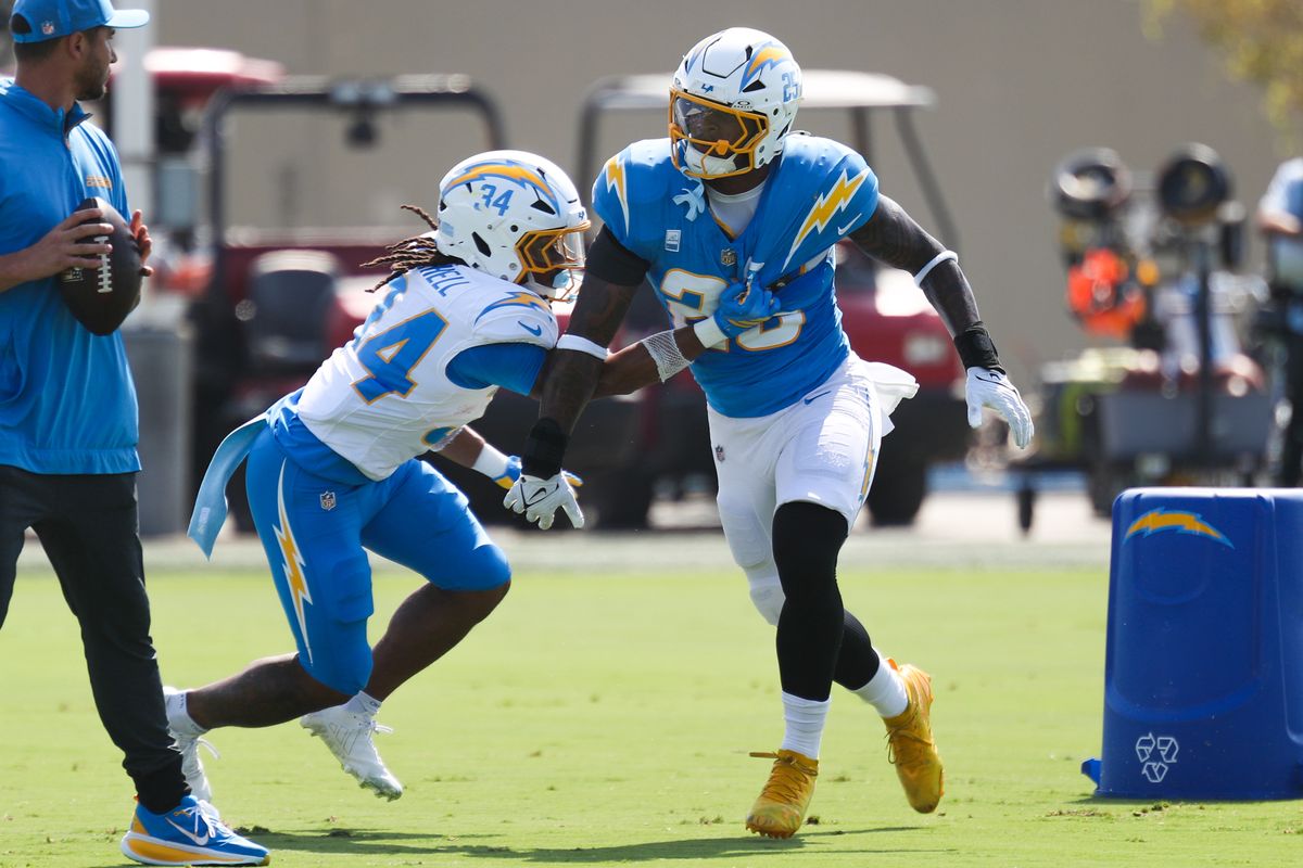 Keaton Mitchell #34 and Junior Colson #25 of the Los Angeles Chargers participate in drills during training camp at The Bolt on August 9, 2026 in El Segundo, California. Keaton Mitchell #34 and Junior Colson #25 of the Los Angeles Chargers participate in drills during training camp at The Bolt on August 9, 2026 in El Segundo, California.