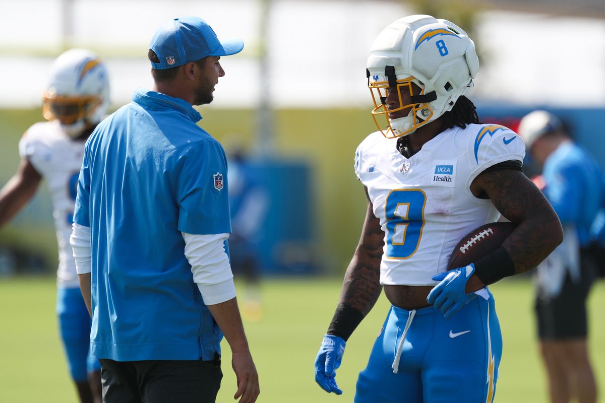 Omarion Hampton #8 of the Los Angeles Chargers speaks with running backs coach Max McCaffrey during training camp at The Bolt on August 9, 2026 in El Segundo, California. Omarion Hampton #8 of the Los Angeles Chargers speaks with running backs coach Max McCaffrey during training camp at The Bolt on August 9, 2026 in El Segundo, California.