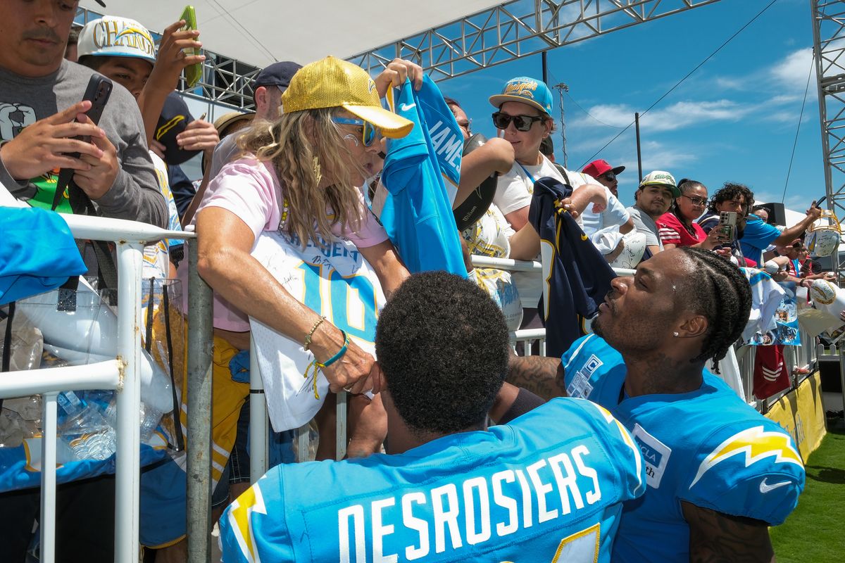 Los Angeles Chargers safety Derwin James Jr. (3) and running back Greg Desrosiers (31) signing merchandise for fans during a joint Chargers and 49ers training camp at The Bolt on Saturday, August 18th in El Segundo, CA. Los Angeles Chargers safety Derwin James Jr. (3) and running back Greg Desrosiers (31) signing merchandise for fans during a joint Chargers and 49ers training camp at The Bolt on Saturday, August 18th in El Segundo, CA.
