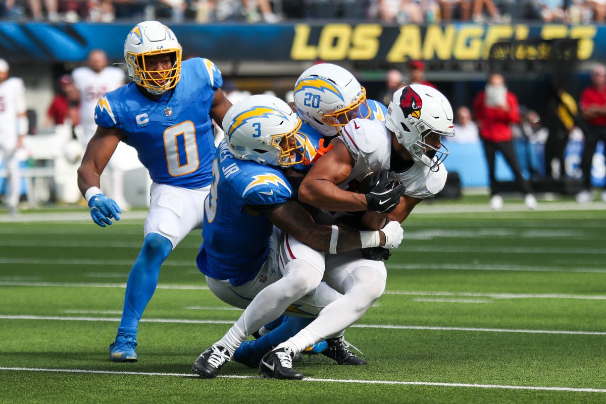 Los Angeles Chargers S Derwin James (3) and CB Cam Hart (20) tackle an Arizona Cardinals player during an NFL game between the Los Angeles Chargers and Arizona Cardinals on Sunday, September 13, 2026 at SoFi Stadium in Inglewood, California. Los Angeles Chargers S Derwin James (3) and CB Cam Hart (20) tackle an Arizona Cardinals player during an NFL game between the Los Angeles Chargers and Arizona Cardinals on Sunday, September 13, 2026 at SoFi Stadium in Inglewood, California.