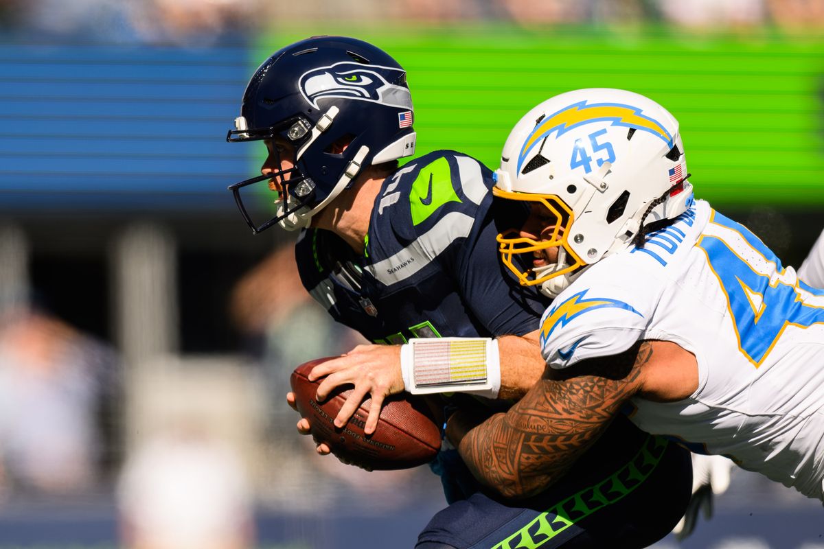 Los Angeles Chargers linebacker Tuli Tuipulotu (45) dives Seattle Seahawks quarterback Sam Darnold (14) during an NFL game between the Los Angeles Chargers and Seattle Seahawks on Sunday, October 4, 2026 at Lumen Field in Seattle, Washington Los Angeles Chargers linebacker Tuli Tuipulotu (45) dives Seattle Seahawks quarterback Sam Darnold (14) during an NFL game between the Los Angeles Chargers and Seattle Seahawks on Sunday, October 4, 2026 at Lumen Field in Seattle, Washington