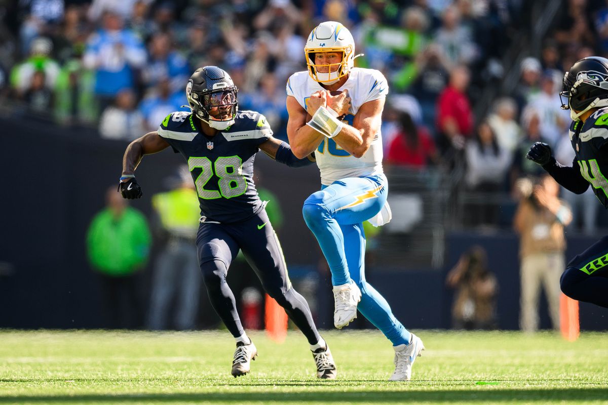 Los Angeles Chargers quarterback Justin Herbert (10) runs the ball with Seattle Seahawks defense on him during an NFL game between the Los Angeles Chargers and Seattle Seahawks on Sunday, October 4, 2026 at Lumen Field in Seattle, Washington Los Angeles Chargers quarterback Justin Herbert (10) runs the ball with Seattle Seahawks defense on him during an NFL game between the Los Angeles Chargers and Seattle Seahawks on Sunday, October 4, 2026 at Lumen Field in Seattle, Washington