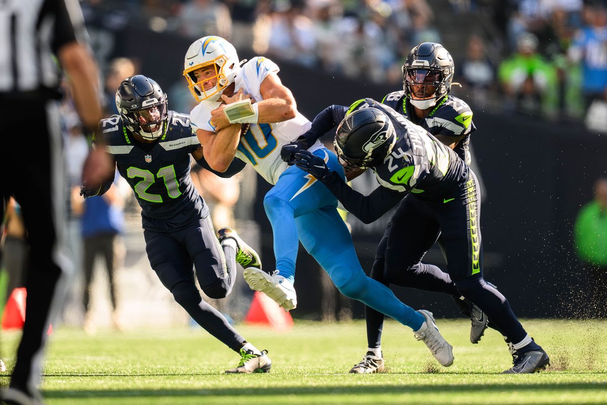 Los Angeles Chargers quarterback Justin Herbert (10) runs the ball with Seattle Seahawks defense on him during an NFL game between the Los Angeles Chargers and Seattle Seahawks on Sunday, October 4, 2026 at Lumen Field in Seattle, Washington Los Angeles Chargers quarterback Justin Herbert (10) runs the ball with Seattle Seahawks defense on him during an NFL game between the Los Angeles Chargers and Seattle Seahawks on Sunday, October 4, 2026 at Lumen Field in Seattle, Washington