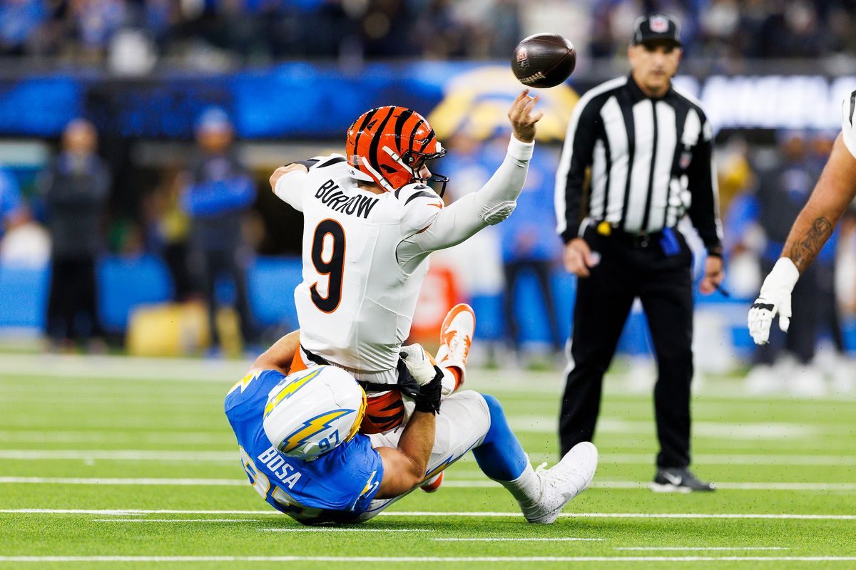 Joe Burrow #9 of the Cincinnati Bengals throws whiles being tackled during the first half against the Los Angeles Chargers at SoFi Stadium on November 17, 2024 in Inglewood, California. Joe Burrow #9 of the Cincinnati Bengals throws whiles being tackled during the first half against the Los Angeles Chargers at SoFi Stadium on November 17, 2024 in Inglewood, California.