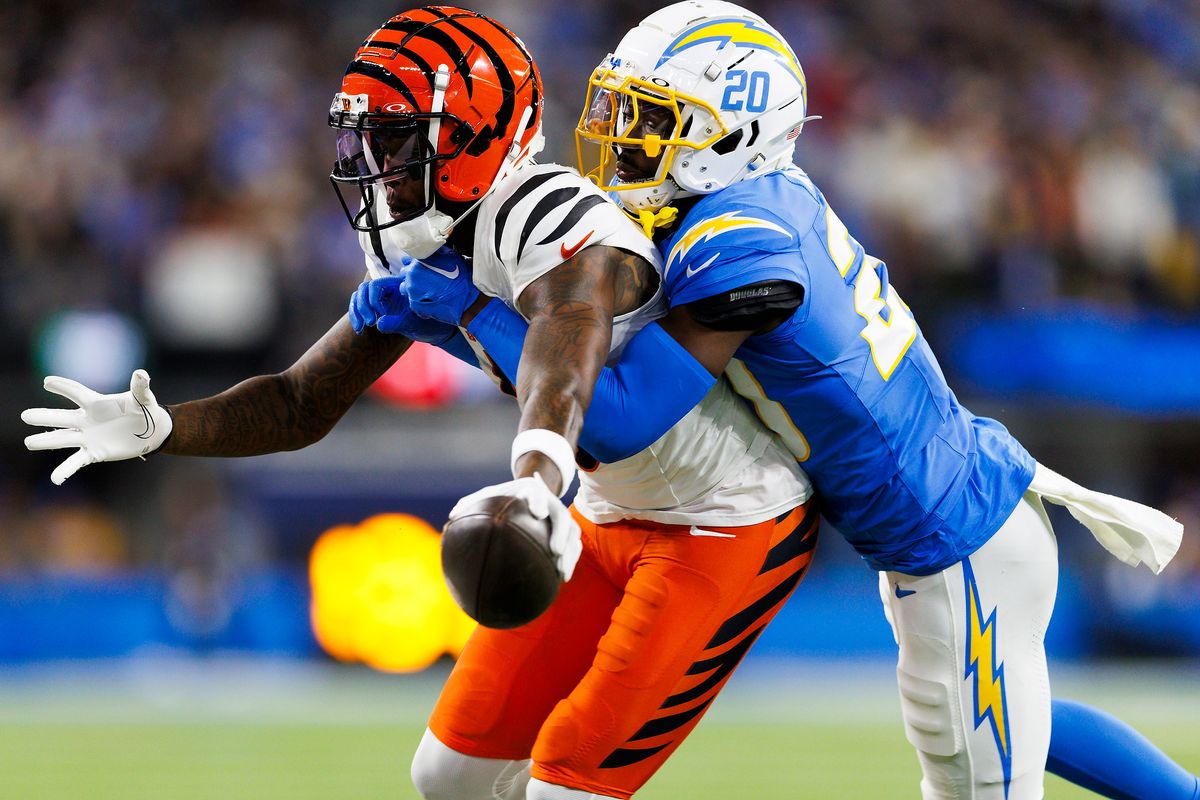 Tee Higgins #5 of the Cincinnati Bengals reaching for a first down against Cam Hart #20 of the Los Angeles Chargers during the first half at SoFi Stadium on November 17, 2024 in Inglewood, California. Tee Higgins #5 of the Cincinnati Bengals reaching for a first down against Cam Hart #20 of the Los Angeles Chargers during the first half at SoFi Stadium on November 17, 2024 in Inglewood, California.