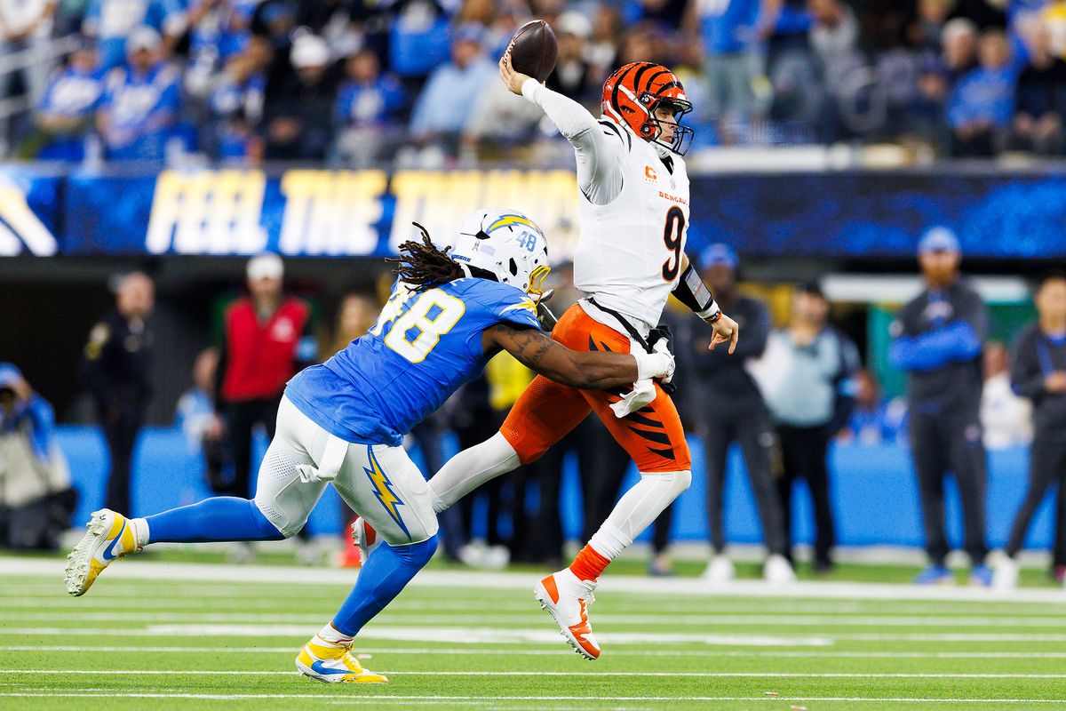Joe Burrow #9 of the Cincinnati Bengals throws on the run while being pressured by Bud Dupree #48 of the Los Angeles Chargers during the second half at SoFi Stadium on November 17, 2024 in Inglewood, California. Joe Burrow #9 of the Cincinnati Bengals throws on the run while being pressured by Bud Dupree #48 of the Los Angeles Chargers during the second half at SoFi Stadium on November 17, 2024 in Inglewood, California.