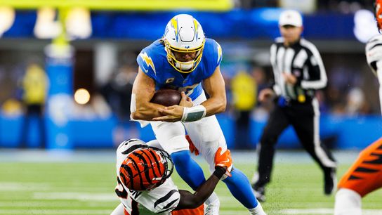 Justin Herbert #10 of the Los Angeles Chargers is tackled by Mike Hilton #21 of the Cincinnati Bengals during the second half at SoFi Stadium on November 17, 2024 in Inglewood, California. Justin Herbert #10 of the Los Angeles Chargers is tackled by Mike Hilton #21 of the Cincinnati Bengals during the second half at SoFi Stadium on November 17, 2024 in Inglewood, California.