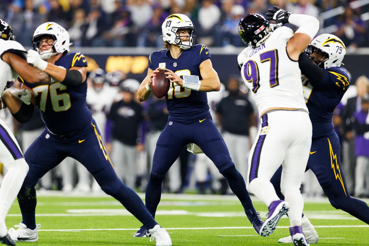 Justin Herbert #10 of the Los Angeles Chargers drops back to pass during the first half against the Baltimore Ravens at SoFi Stadium on November 25, 2024 in Inglewood, California. 