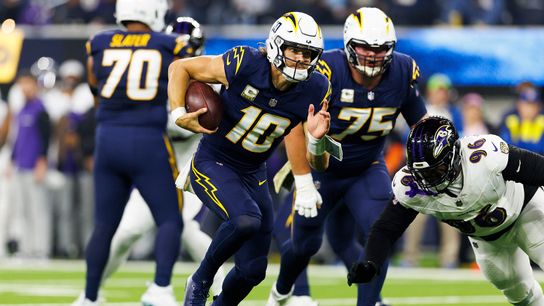 Justin Herbert #10 of the Los Angeles Chargers runs with the ball during the first half against the Baltimore Ravens at SoFi Stadium on November 25, 2024 in Inglewood, California. 