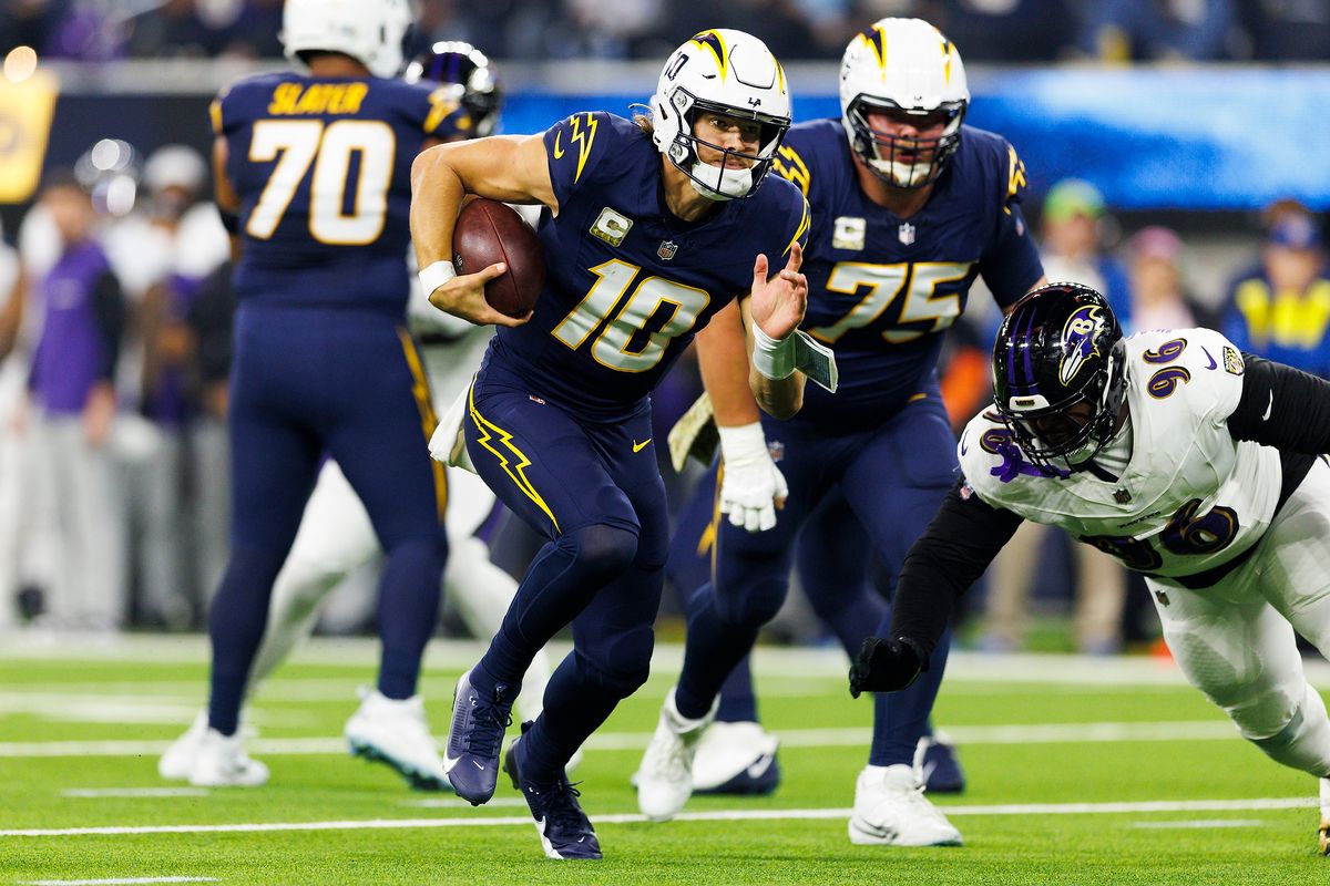 Justin Herbert #10 of the Los Angeles Chargers runs with the ball during the first half against the Baltimore Ravens at SoFi Stadium on November 25, 2024 in Inglewood, California. 