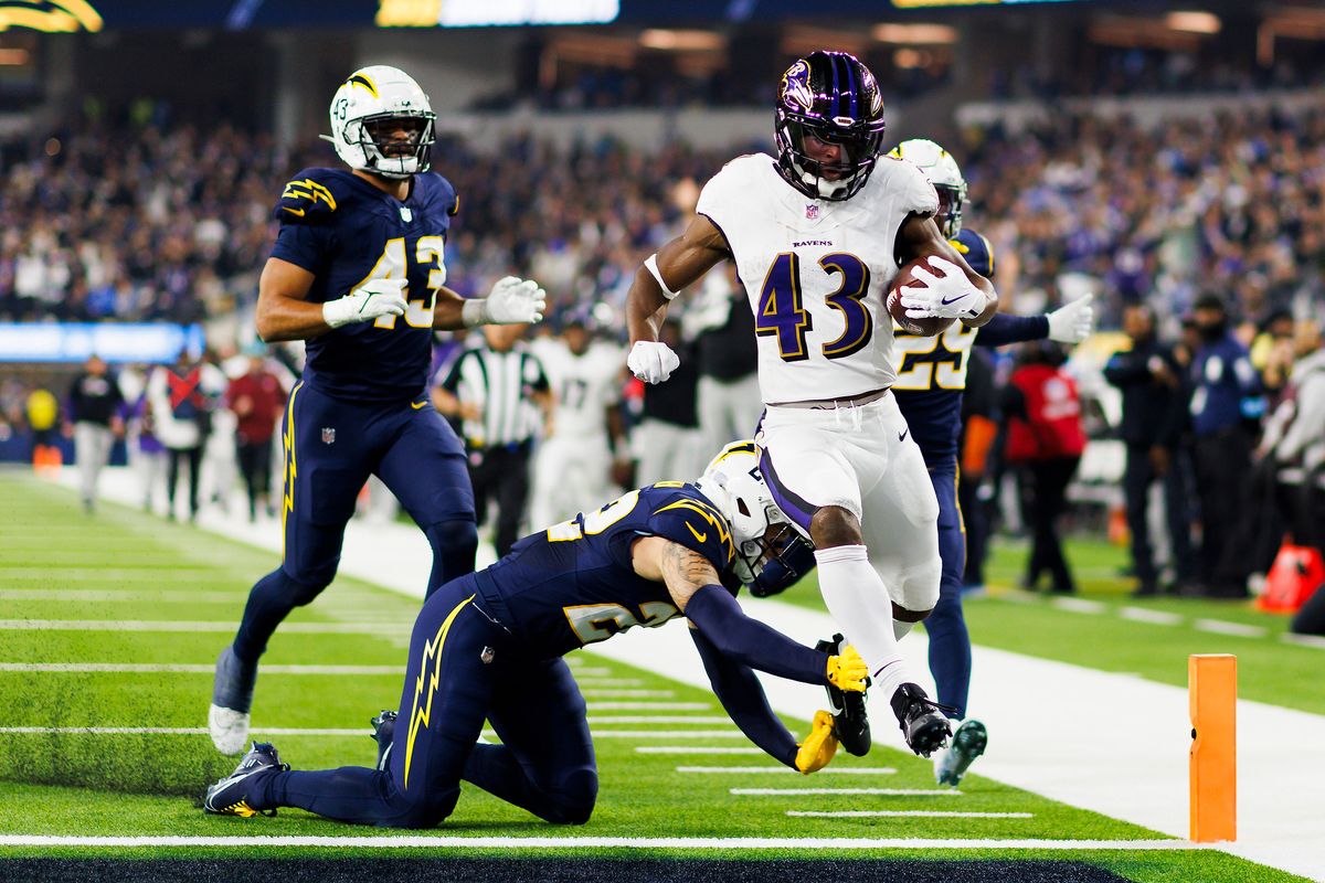 Justice Hill #43 of the Baltimore Ravens scores during the first half against the Los Angeles Chargers at SoFi Stadium on November 25, 2024 in Inglewood, California. 