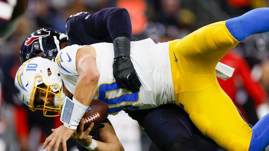 Denico Autry #96 of the Houston Texans sacks Justin Herbert #10 of the Los Angeles Chargers in the third quarter during the AFC Wild Card Playoff game at NRG Stadium on January 11, 2025 in Houston, Texas.