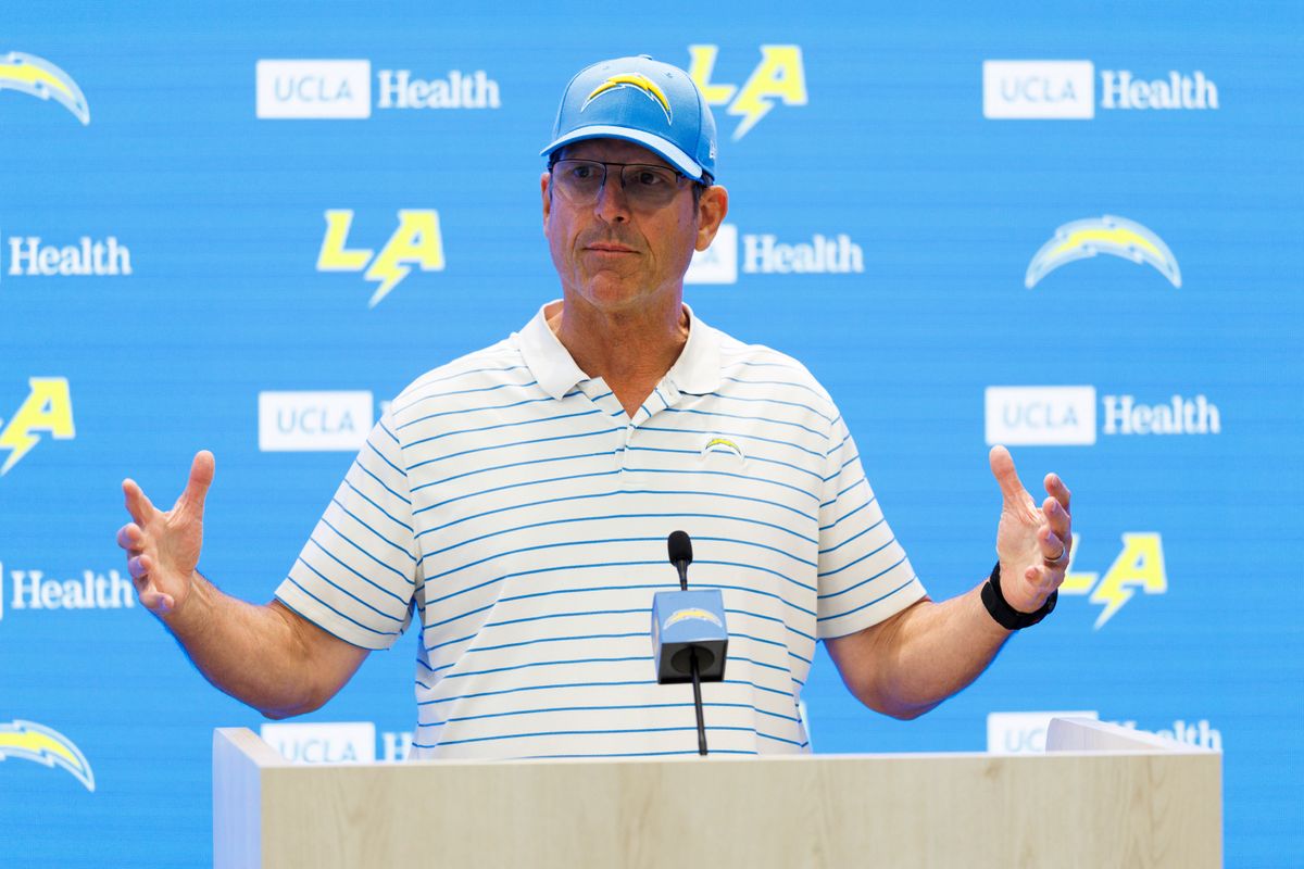 Jim Harbaugh of the Los Angeles Chargers talks with members of the media before mandatory minicamp at The Bolt on June 12, 2025 in El Segundo, California. 
