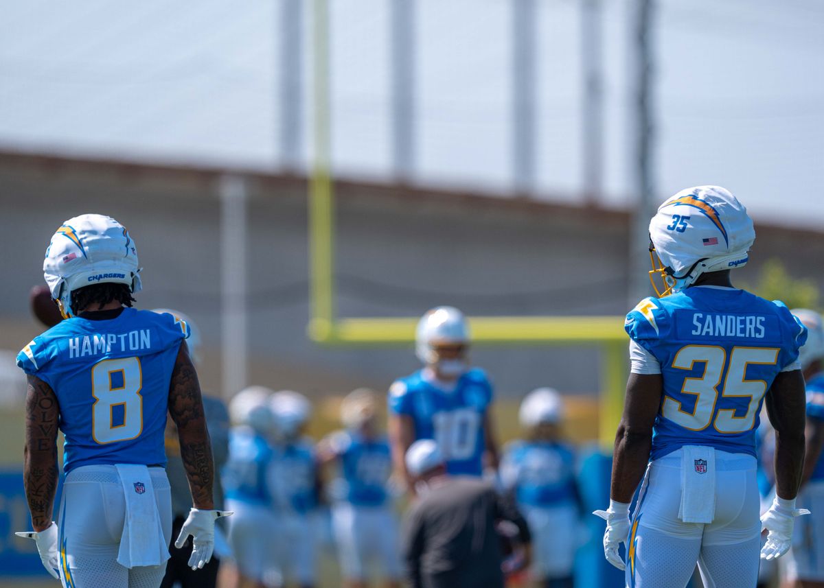 Los Angeles Chargers' running backs, Omarion Hampton 8 and Raheim Sanders 35, prepare to take handoffs from Justin Herbert 10 during training camp July 17, 2025 at The Bolt training facility in El Segundo, CA.